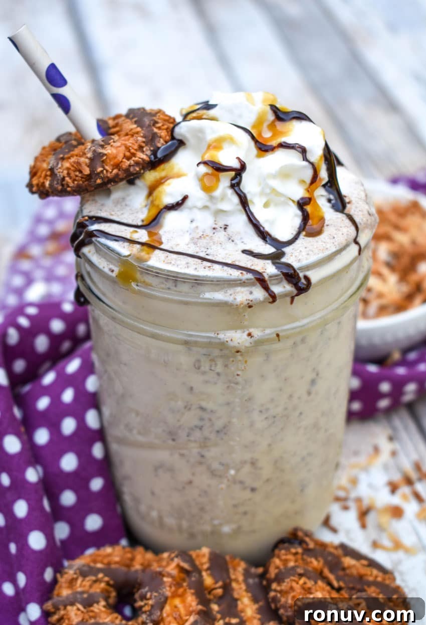 Samoa Cookie Milkshake Recipe with Caramel and Toasted Coconut 8 a samoa cookie milkshake in a small glass jar on a wooden table