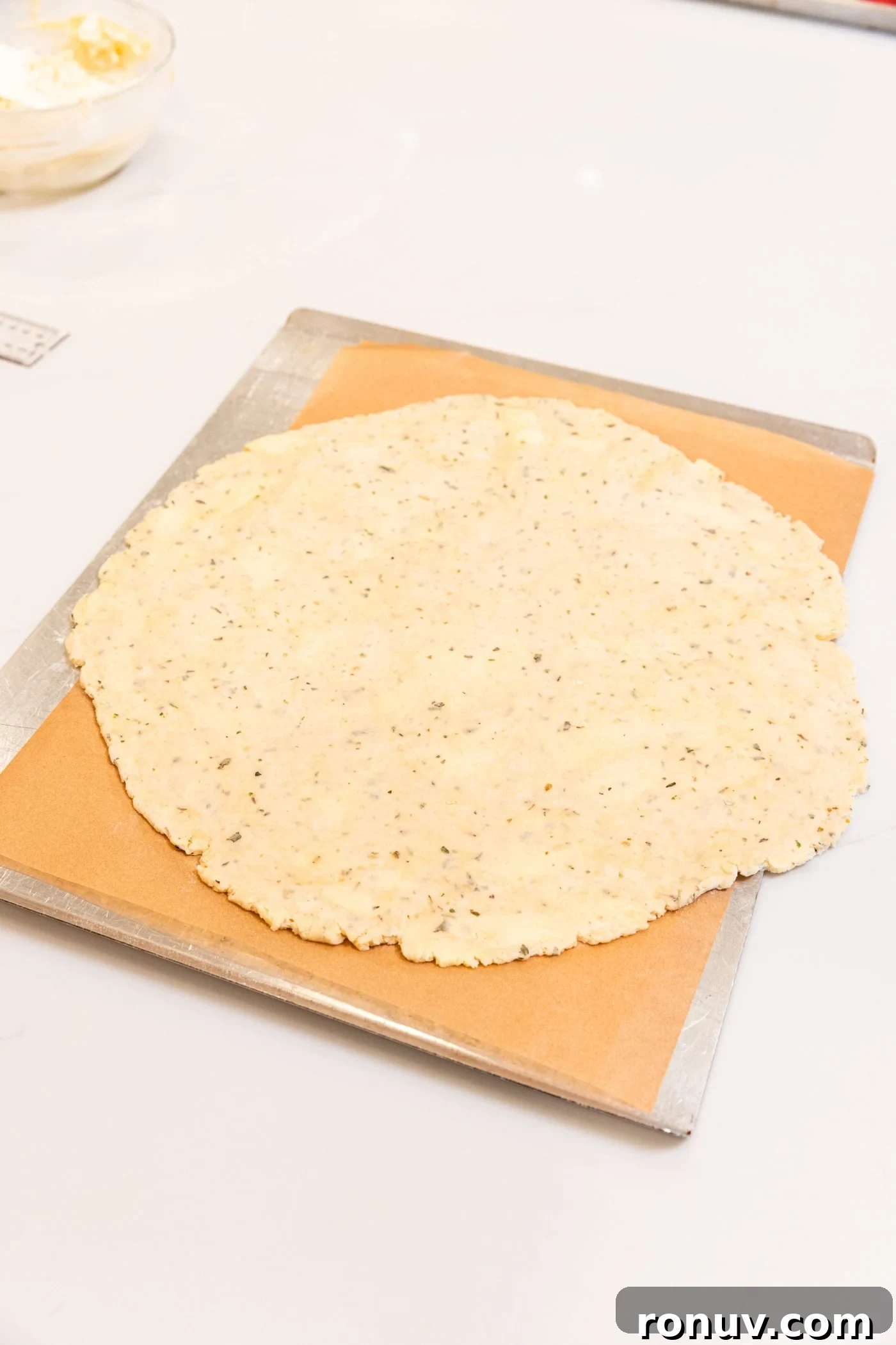 Fresh Tomato Galette Recipe with Basil 10 Rolled out piece of dough sitting on parchment-lined baking sheet before being baked.