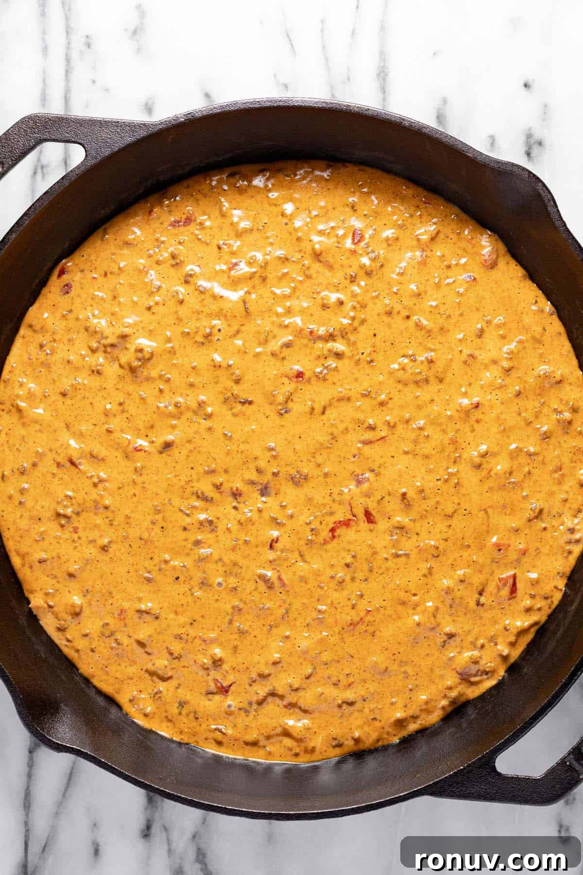 Creamy Cheesy Rotel Dip Recipe 6 Cast iron skillet filled with cheesy Velveeta rotel dip.