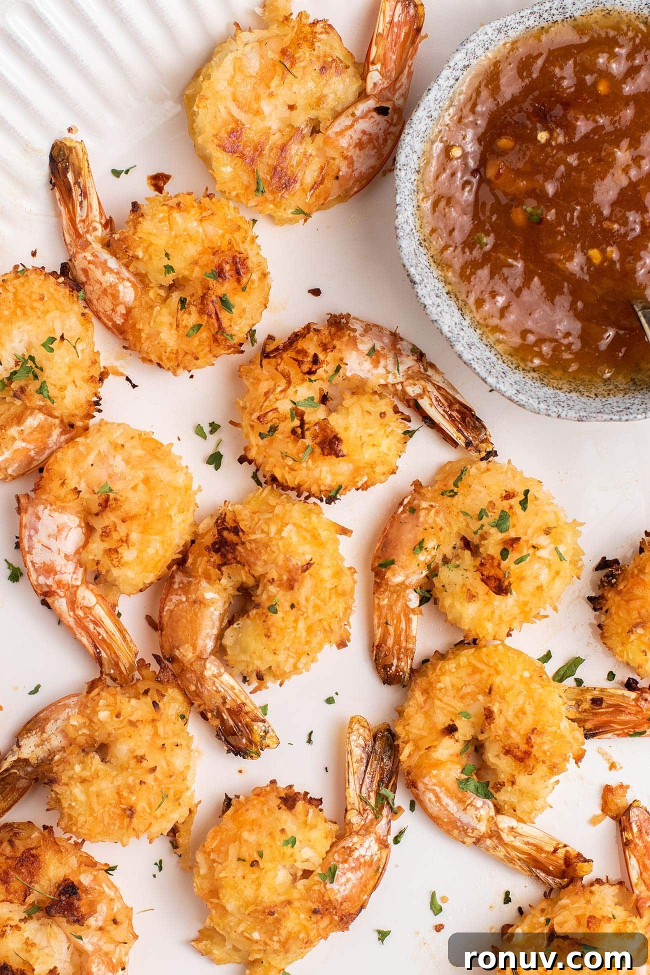 Crispy Baked Coconut Shrimp with Apricot-Chili Dip 2 A platter of crispy baked coconut shrimp shown with an apricot dipping sauce.