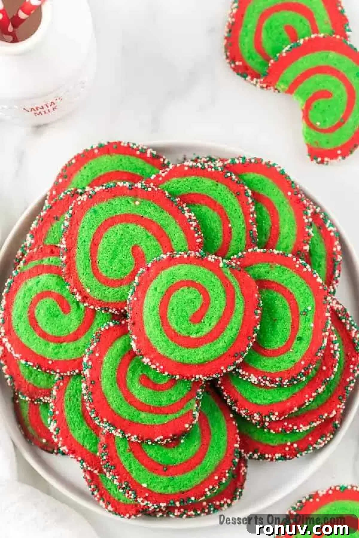 Christmas pinwheel cookies are super easy to make. From holiday parties and more, these easy cookies will be the star and sure to impress. Old fashioned red and green sugar cookies are the best. Make this easy Christmas cookie today. Christmas Pinwheel Cookies on a cookie platter