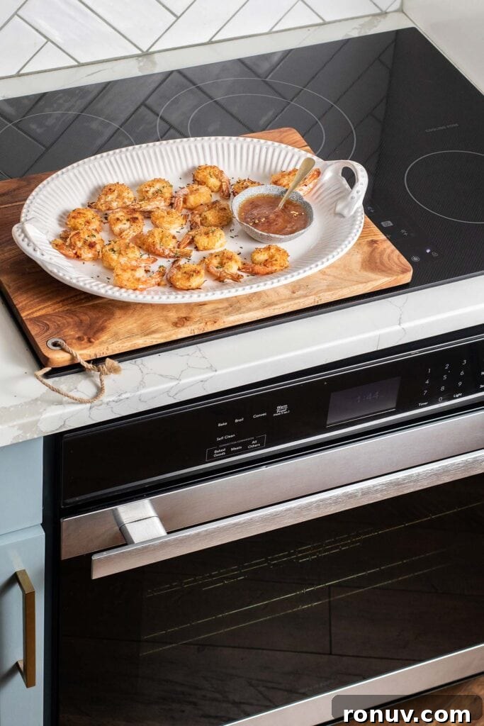 Crispy Baked Coconut Shrimp with Apricot-Chili Dip 4 A platter of coconut shrimp shown sitting on top of a convection oven.