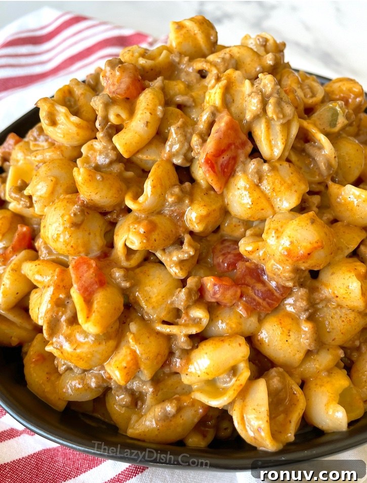 Quick Taco Macaroni and Cheese Dinner Recipe 2 Try mixing taco seasoned ground beef with boxed macaroni and cheese! Seriously, the best comfort food for your picky family, and on a budget! This cheap meal is so yummy and full of flavor, yet easy to make with just a few cheap ingredients. My picky eaters always lick their plates clean. It's great for the entire family!