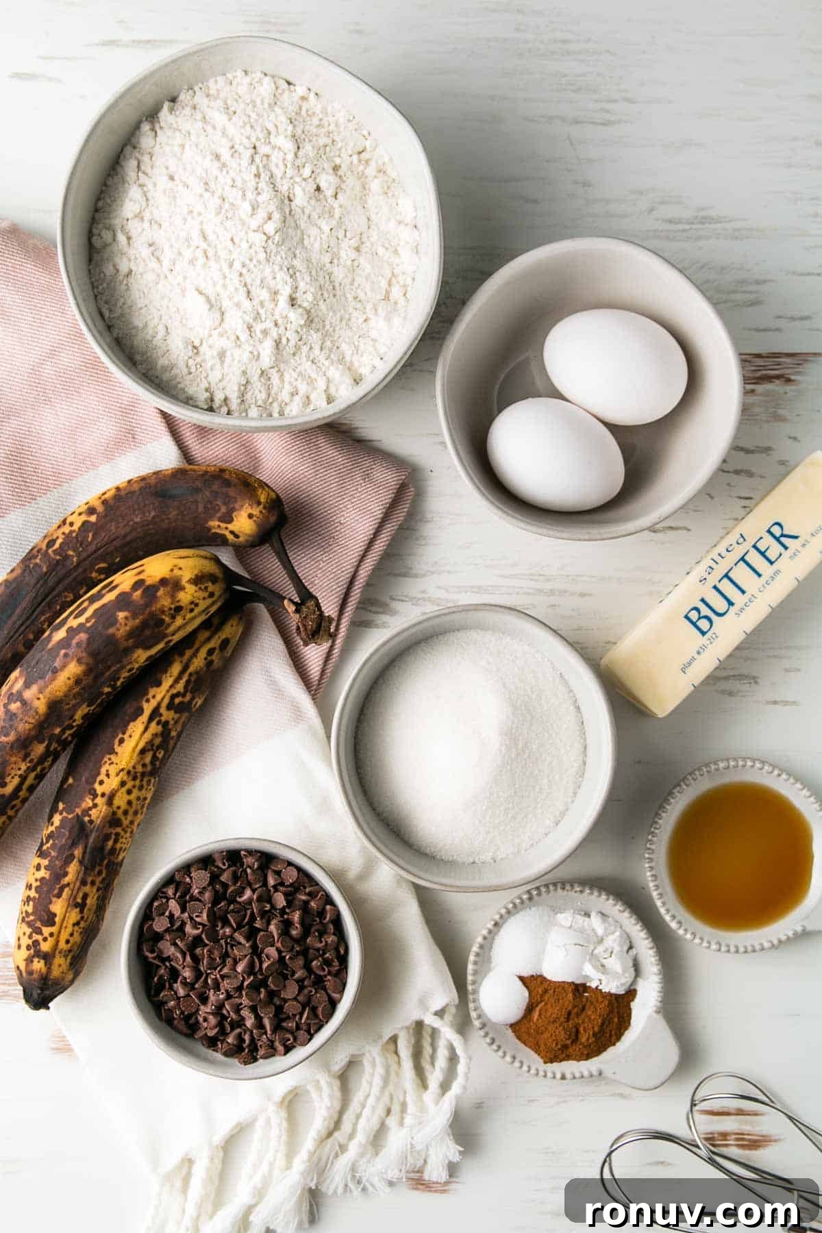Gluten-Free Banana Muffins with Chocolate Chips 3 Ingredients for gluten-free chocolate chip banana muffins measured out in bowls next to three over-ripe bananas.