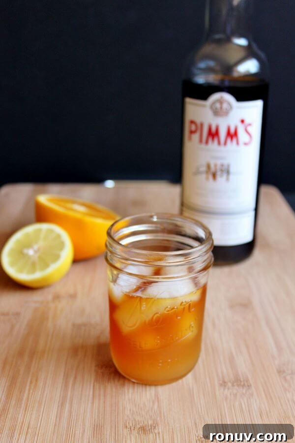 How to Make Pimm's Sundowner Cocktail 5 Making a Pimm's Sundowner, adding liquid ingredients.