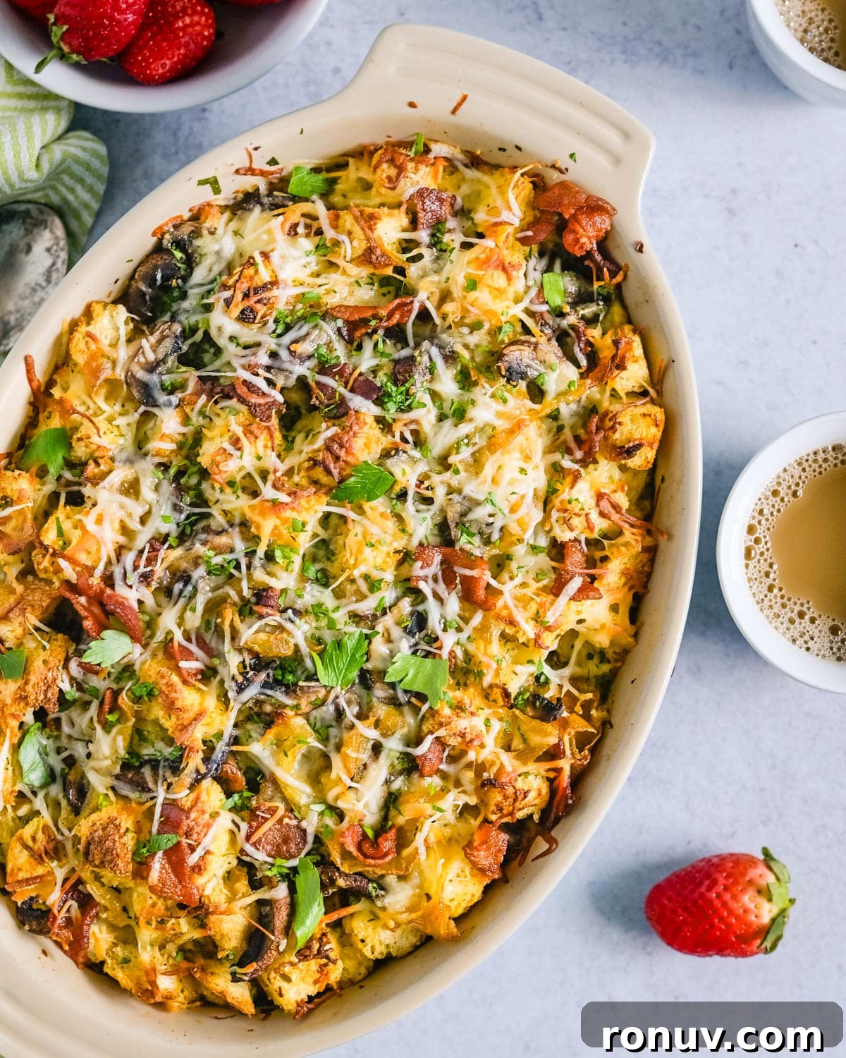 Overnight Bacon and Egg Strata Recipe 7 Baked bacon breakfast strata with coffee and fresh berries on the side.
