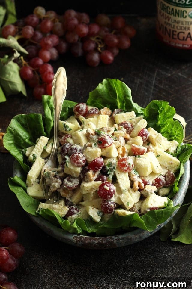 Vegan Waldorf Salad Recipe with Apples, Celery and Walnuts 6 Healthy Vegan Waldorf Salad Recipe - with Apples and Grapes on the Table and a Fork in the Salad