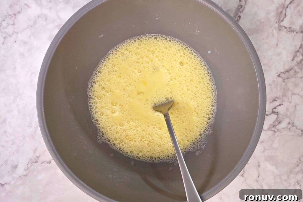 Air Fryer Corn Fritters: Crispy Summer Snack Recipe 6 whisk eggs and milk in a bowl