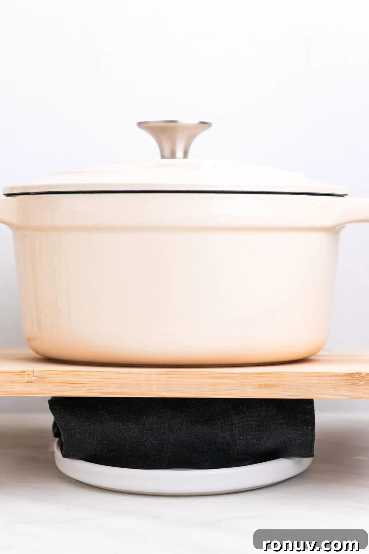 Freeze Tofu for Firmer Texture and Longer Storage 11 Tofu being pressed with a kitchen towel and a heavy pot on top