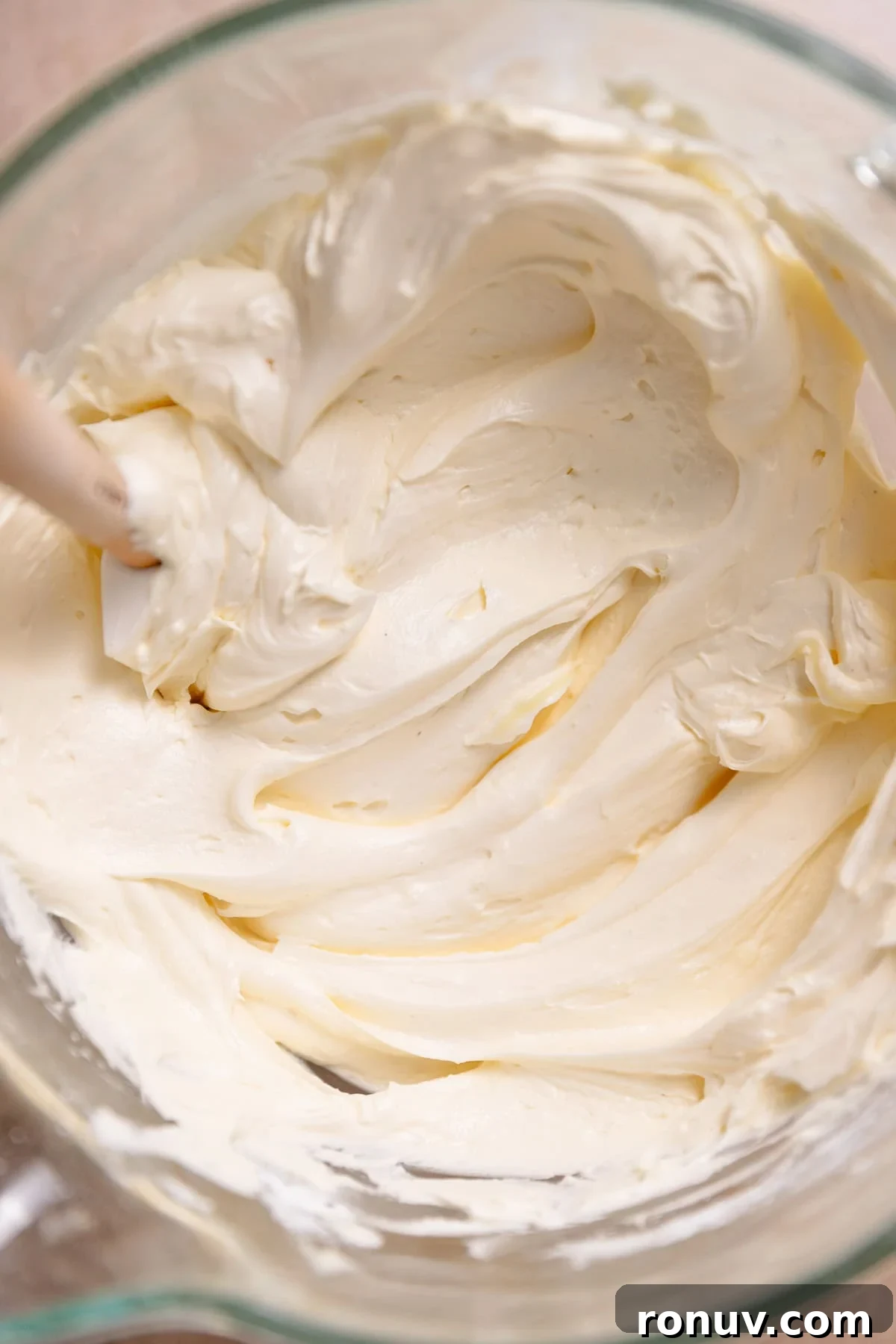 Homemade Funfetti Cake That Beats the Bakery 7 Vanilla buttercream frosting in a glass mixer bowl with a spatula.