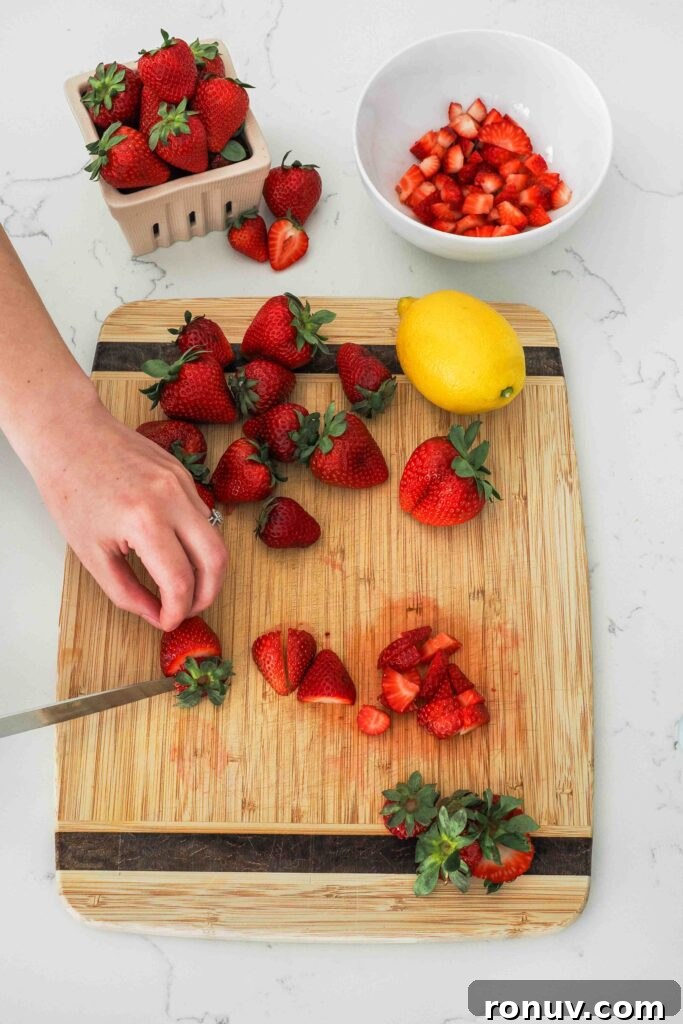 How to Make Small-Batch Strawberry Jam 4 Strawberries being diced on a cutting board.