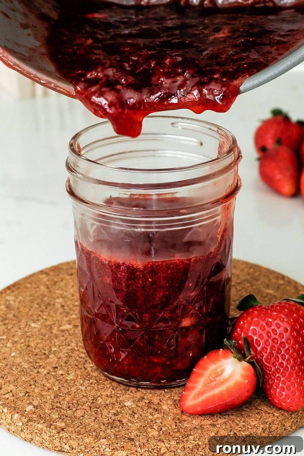 How to Make Small-Batch Strawberry Jam 10 Strawberry jam is poured into a jelly jar.