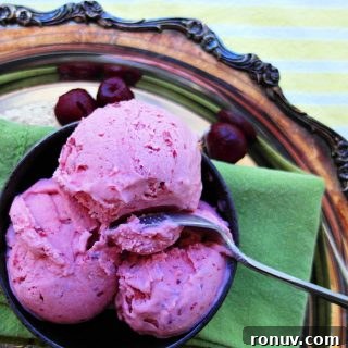 overhead shot of cherry ice cream in a bowl on a silver tray