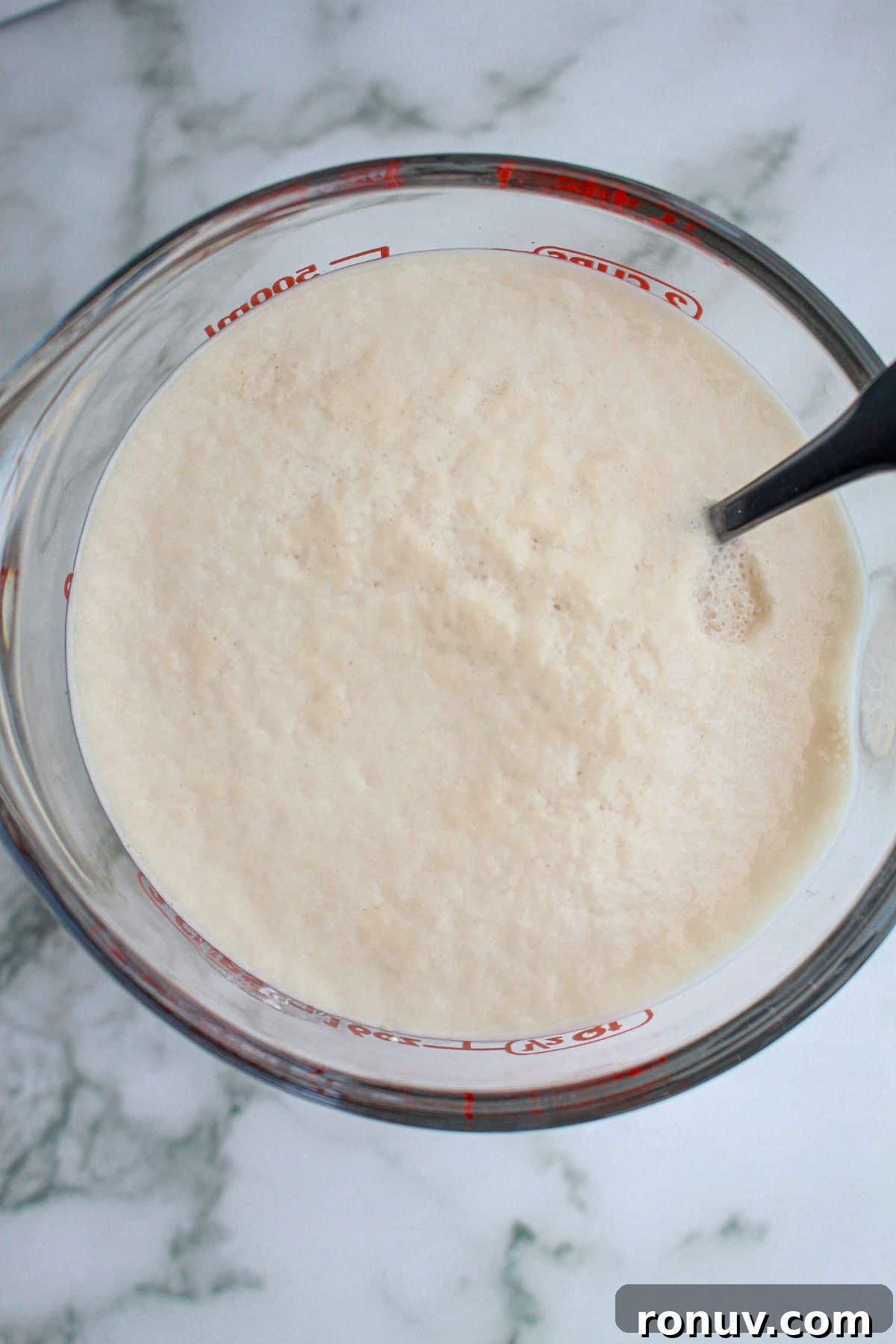 Tomato Focaccia: Classic Italian Bread 4 yeast blooming in a glass mixing bowl.