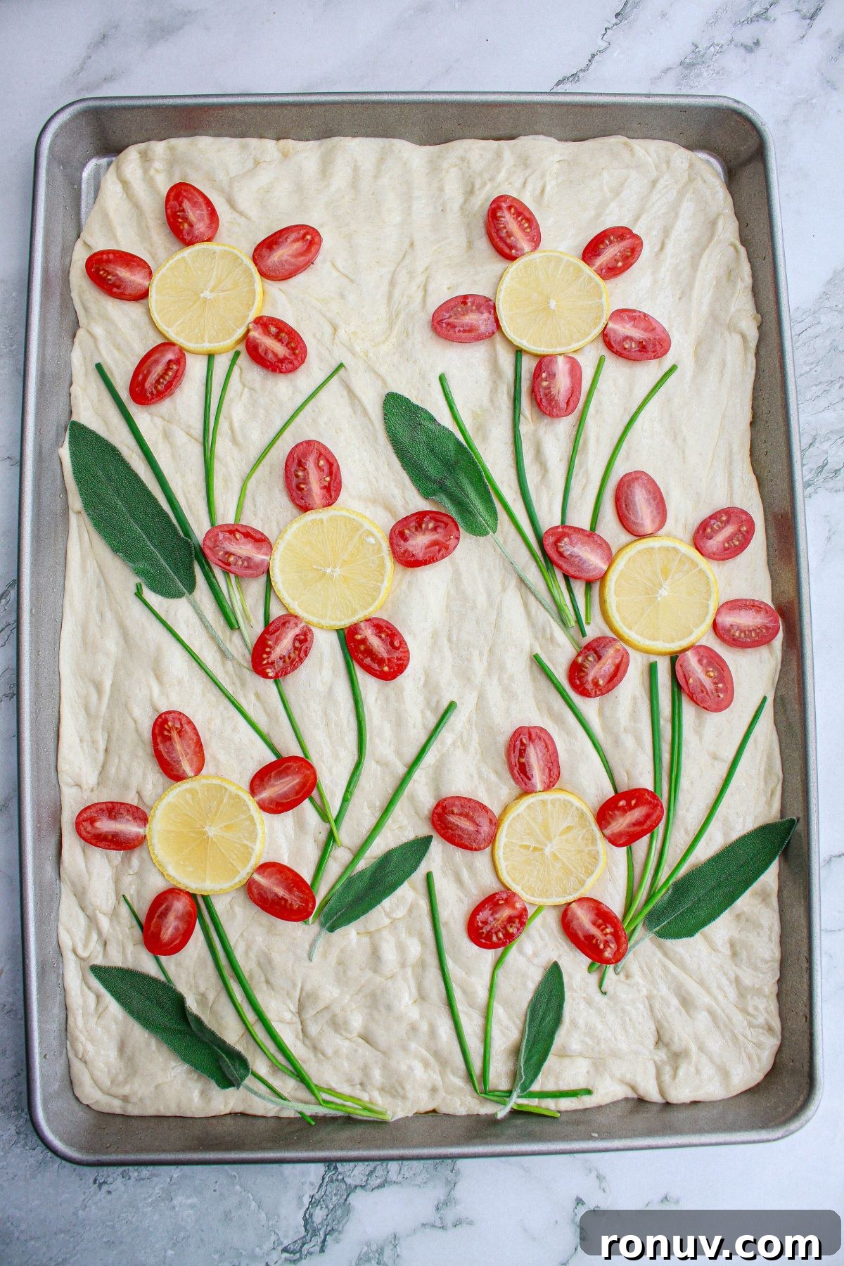 Tomato Focaccia: Classic Italian Bread 8 raw finished tomato focaccia bread on a parchment lined baking sheet,