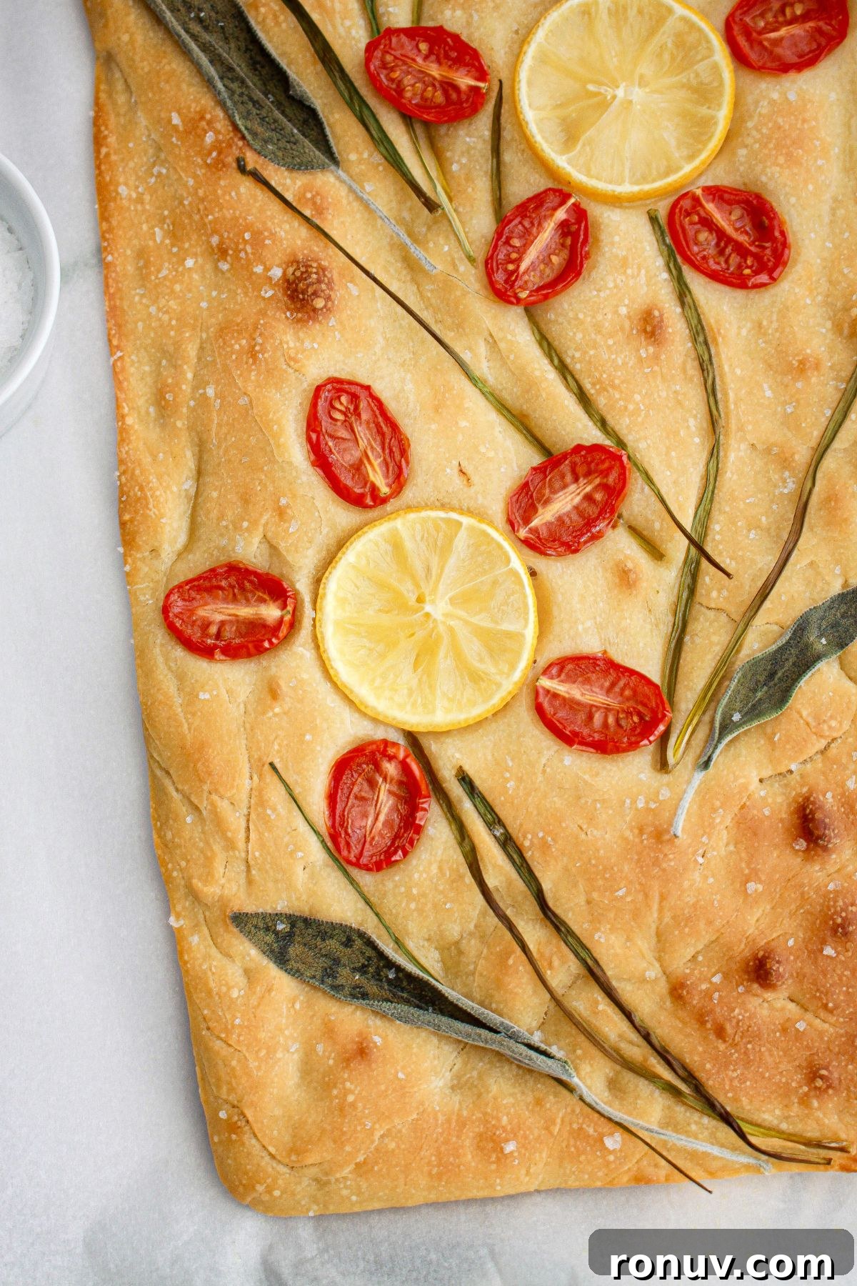 Tomato Focaccia: Classic Italian Bread 9 finished tomato focaccia bread on a parchment lined baking sheet,