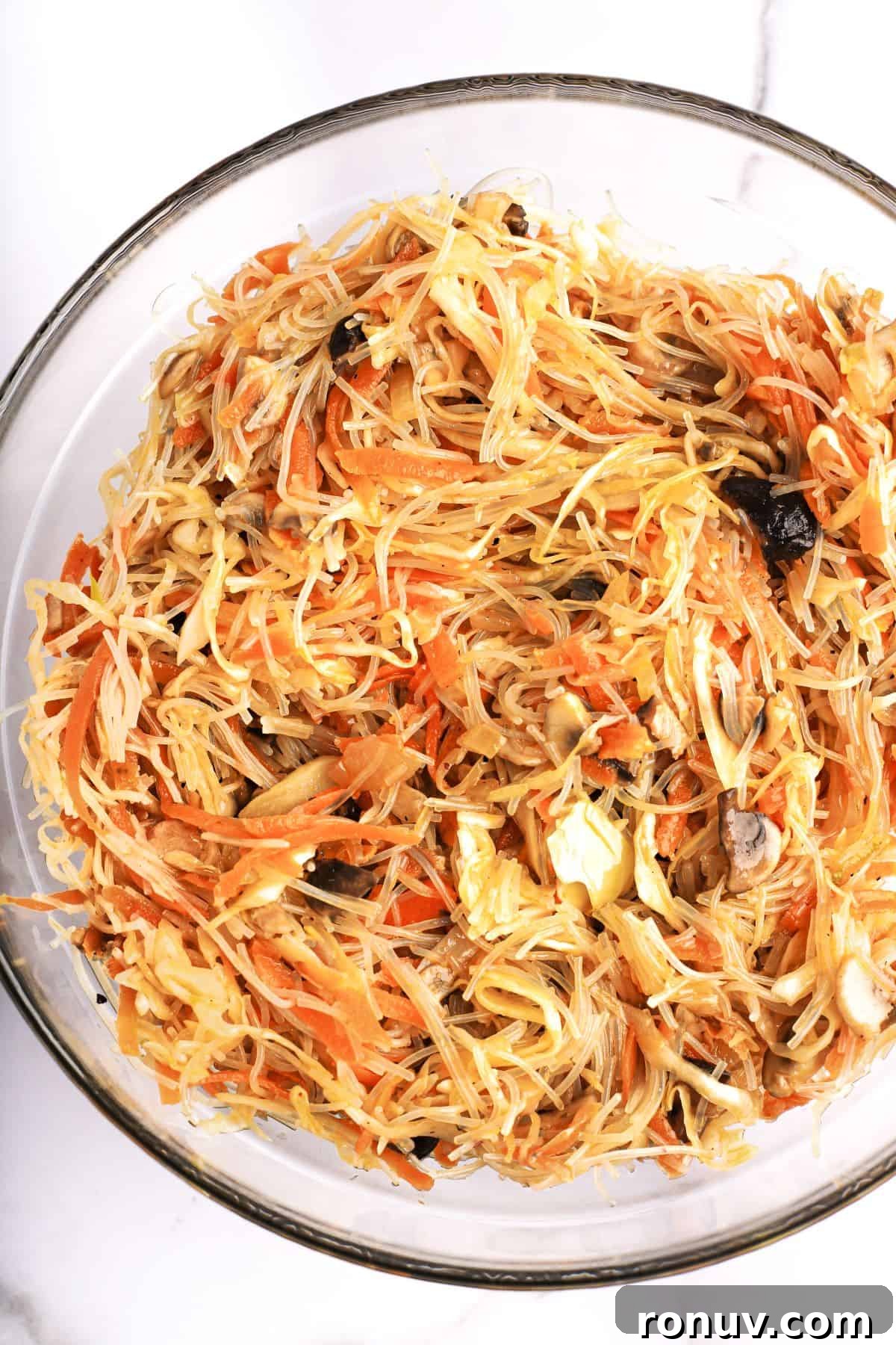 Crispy Golden Vegetable Spring Rolls with Sweet Chili Sauce 4 A bowl of spring roll filling, made with rice vermicelli, carrots, mushrooms, and more.