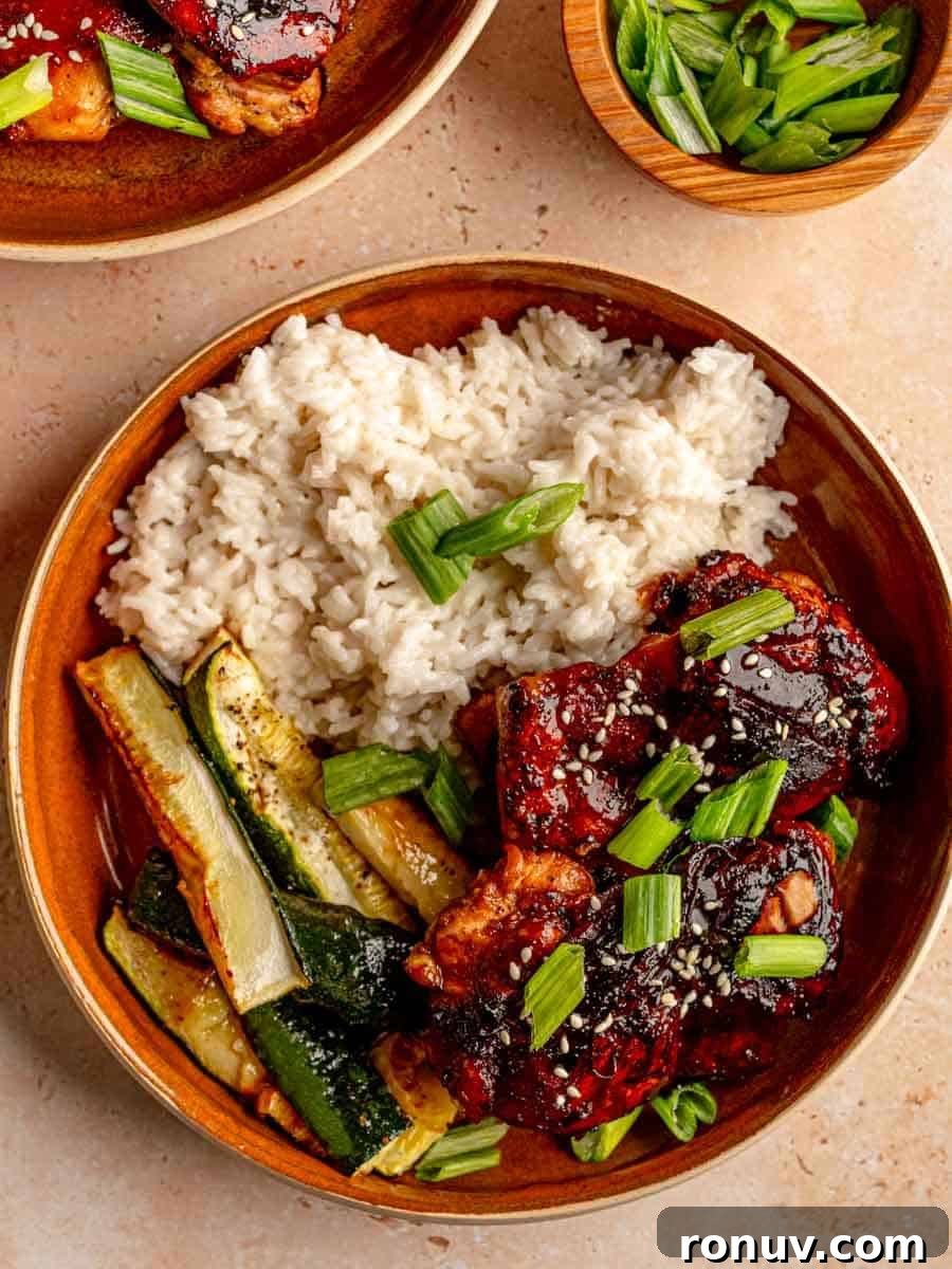 Sticky Honey Garlic Chicken Thighs for Quick Weeknight Dinner 2 Plate of rice, zucchini and chicken thighs.