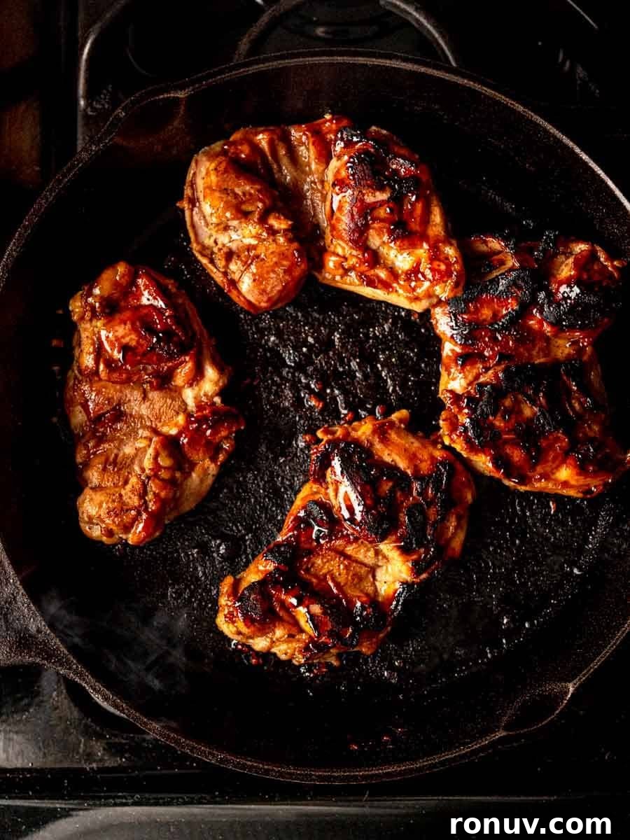 Sticky Honey Garlic Chicken Thighs for Quick Weeknight Dinner 6 Chicken cooked on a skillet.