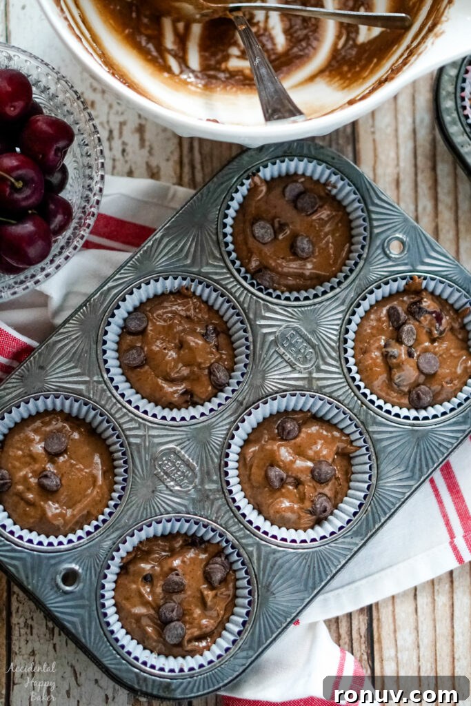 Homemade Cherry Chocolate Muffins Recipe 7 Cherry Chocolate muffin batter is scooped into muffin tins 2/3 full.
