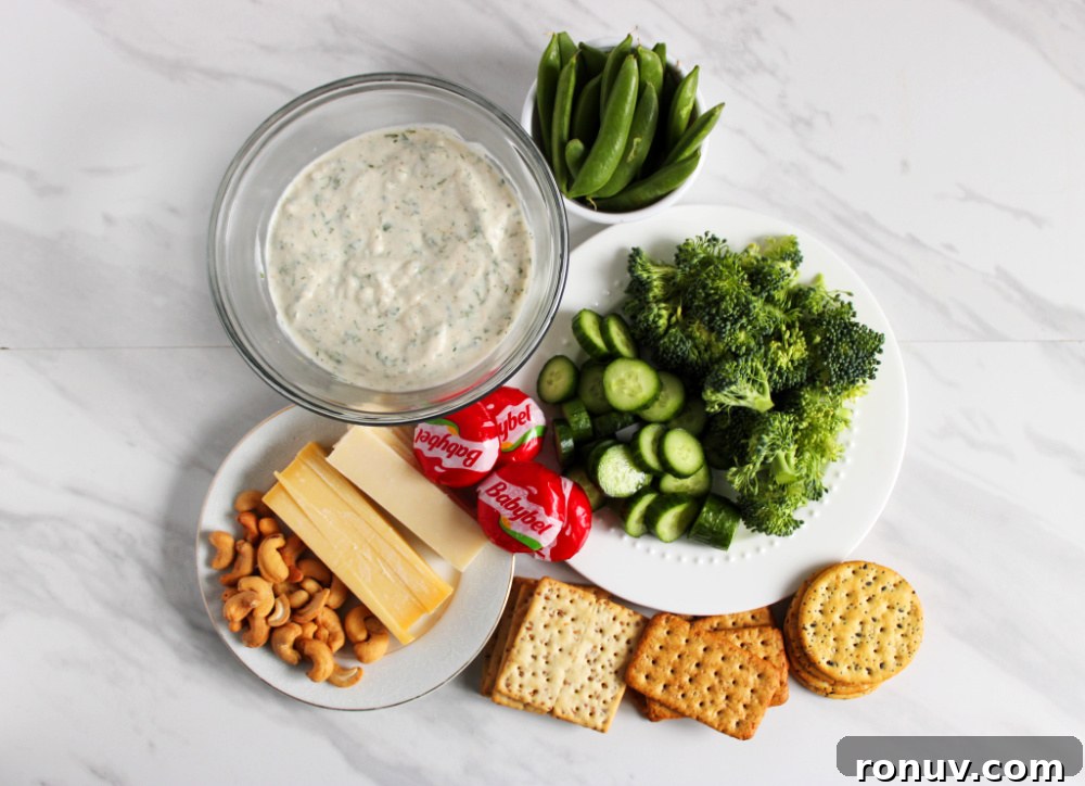 DIY Adorable Easter Charcuterie Board Ideas 5 Ingredients laid out for an Easter charcuterie board: crackers, cheeses, dip, veggies and nuts